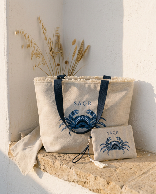 Crab Linen Tote & Pouch Set in warm natural light beside a whitewashed wall