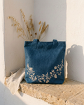 Denim Floral Tote against a whitewashed wall in warm natural light